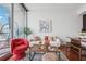 Bright living room with modern furniture, wood floors, and a balcony with a hanging chair at 1080 Peachtree Ne St # 2416, Atlanta, GA 30309