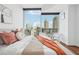 Bright and inviting main bedroom featuring floor-to-ceiling windows with a city view at 1080 Peachtree Ne St # 2416, Atlanta, GA 30309