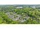 Aerial view of a townhome community surrounded by lush green trees, near an urban center at 12 Valley Forge Nw Pl # 215, Atlanta, GA 30318