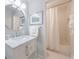 Bright bathroom with a marble countertop vanity and tiled shower at 12 Valley Forge Nw Pl # 215, Atlanta, GA 30318
