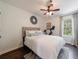 Bedroom featuring a plush headboard, modern light fixture, and exercise equipment at 12 Valley Forge Nw Pl # 215, Atlanta, GA 30318