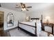 Spacious bedroom featuring paneled walls, hardwood floors, and a large mirror at 12 Valley Forge Nw Pl # 215, Atlanta, GA 30318