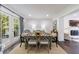Sunlit dining area with a rustic wooden table, stylish seating, and views of the outdoor greenery at 12 Valley Forge Nw Pl # 215, Atlanta, GA 30318