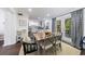 Charming dining area open to the kitchen, featuring a rustic table and stylish black chairs at 12 Valley Forge Nw Pl # 215, Atlanta, GA 30318