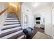 View of foyer with hardwood floors, leading to a staircase and an open living space at 12 Valley Forge Nw Pl # 215, Atlanta, GA 30318