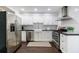 This modern kitchen boasts stainless steel appliances, white cabinets, and an easy-to-clean subway tile backsplash at 12 Valley Forge Nw Pl # 215, Atlanta, GA 30318
