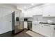 Efficient kitchen features stainless steel appliances, white cabinets, and a farmhouse sink at 12 Valley Forge Nw Pl # 215, Atlanta, GA 30318
