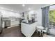 Well-lit kitchen with white cabinets, stainless steel appliances, and a cozy breakfast nook at 12 Valley Forge Nw Pl # 215, Atlanta, GA 30318
