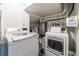 Laundry room with washer, dryer, and shelving for cleaning supplies at 12 Valley Forge Nw Pl # 215, Atlanta, GA 30318