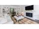 Cozy living room with a fireplace, built-in shelves, and a view into the dining area at 12 Valley Forge Nw Pl # 215, Atlanta, GA 30318