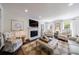 Inviting living room featuring a fireplace, built-in shelves, and ample seating at 12 Valley Forge Nw Pl # 215, Atlanta, GA 30318