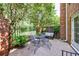 Cozy patio area with iron furniture and landscaping and privacy fence at 12 Valley Forge Nw Pl # 215, Atlanta, GA 30318