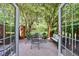 Charming patio area with table, chairs, and a bench surrounded by lush greenery at 12 Valley Forge Nw Pl # 215, Atlanta, GA 30318