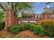 An elegant entrance with brick columns and lush landscaping showcasing the Westover Plantation community sign at 12 Valley Forge Nw Pl # 215, Atlanta, GA 30318