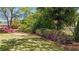 Spacious backyard with lush landscaping and wrought iron fence at 222 Rippling Nw Dr, Marietta, GA 30064