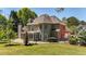 Spacious backyard featuring a well-manicured lawn and a house with an enclosed back porch area at 222 Rippling Nw Dr, Marietta, GA 30064