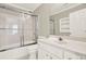 Bathroom featuring a shower-tub combo, white vanity and mirror at 222 Rippling Nw Dr, Marietta, GA 30064