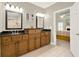 Bathroom boasts double sinks with granite countertops and cabinetry with access to the main bedroom at 222 Rippling Nw Dr, Marietta, GA 30064