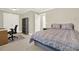 Comfortable bedroom featuring a bed with decorative comforter, a desk, and ample closet space at 222 Rippling Nw Dr, Marietta, GA 30064