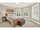 Bedroom with neutral tones, large windows and a bench at the end of the bed at 222 Rippling Nw Dr, Marietta, GA 30064