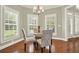 Cozy dining area with a round table, patterned chairs, shuttered windows, and hardwood flooring at 222 Rippling Nw Dr, Marietta, GA 30064