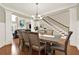 Formal dining room featuring hardwood floors, staircase, and modern light fixture at 222 Rippling Nw Dr, Marietta, GA 30064