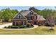 Stately brick home with manicured lawn and mature trees showcases curb appeal at 222 Rippling Nw Dr, Marietta, GA 30064