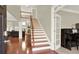 Foyer with hardwood floors, staircase, and views into the living room at 222 Rippling Nw Dr, Marietta, GA 30064