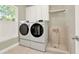 Well-equipped laundry room with modern washer and dryer and convenient pet washing station at 222 Rippling Nw Dr, Marietta, GA 30064