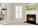 Bright living room features a fireplace, built-in shelves and is illuminated by a window with shuttered blinds at 222 Rippling Nw Dr, Marietta, GA 30064