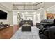 Spacious living room with hardwood floors and staircase features a cozy seating area under a high ceiling at 222 Rippling Nw Dr, Marietta, GA 30064