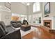 Bright living room boasts fireplace, hardwood floors, and large windows for natural light at 222 Rippling Nw Dr, Marietta, GA 30064