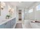 Bright bathroom with double vanity, soaking tub, glass shower, and walk in closet at 5345 Keepsake Court, Cumming, GA 30040