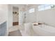 Bright bathroom with double vanity, soaking tub, glass shower, and walk-in closet at 5345 Keepsake Court, Cumming, GA 30040
