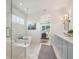 Bright bathroom with double vanity, soaking tub, glass shower, and view into main bedroom at 5345 Keepsake Court, Cumming, GA 30040