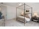 Neutral bedroom featuring a four-poster bed, side tables, and soft lighting at 5345 Keepsake Court, Cumming, GA 30040