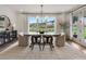 Sunlit dining room with modern chandelier, large window, and stylish furnishings for comfortable dining at 5345 Keepsake Court, Cumming, GA 30040