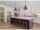 Bright kitchen features a large island with pendant lighting, stainless steel appliances, and a walk-in pantry at 5345 Keepsake Court, Cumming, GA 30040