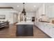 A stylish kitchen with a large island, stainless steel appliances, and hardwood floors at 5345 Keepsake Court, Cumming, GA 30040