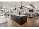 Open concept kitchen with a central island, seamlessly connecting to the living room and dining area at 5345 Keepsake Court, Cumming, GA 30040