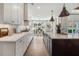 Gourmet kitchen with white cabinets, stainless appliances, a large island, and an adjacent dining area at 5345 Keepsake Court, Cumming, GA 30040
