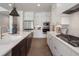 Bright kitchen with white cabinets, stainless steel appliances, and dark brown island at 5345 Keepsake Court, Cumming, GA 30040