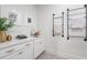 Contemporary laundry room with white cabinets, quartz countertop, and industrial towel racks at 5345 Keepsake Court, Cumming, GA 30040
