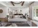 Open-concept living room with white cabinets in the kitchen and large windows overlooking the outdoors at 5345 Keepsake Court, Cumming, GA 30040
