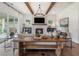 Bright living room featuring wood beams, a stone fireplace, and an open floor plan at 5345 Keepsake Court, Cumming, GA 30040