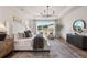 Bright main bedroom features a large window, tray ceiling, and elegant decorative rug at 5345 Keepsake Court, Cumming, GA 30040