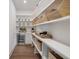 Well-organized walk-in pantry with custom shelving, counter space, and beverage cooler at 5345 Keepsake Court, Cumming, GA 30040