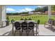 Covered patio with outdoor dining area overlooking a green backyard at 5345 Keepsake Court, Cumming, GA 30040
