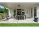 Inviting covered patio featuring dining set, outdoor seating, and a view to the inside at 5345 Keepsake Court, Cumming, GA 30040