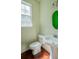 Bathroom with white toilet and sink with faucet, and hardwood floors and green and white walls at 743 Pecan Knoll Dr # 5, Marietta, GA 30008